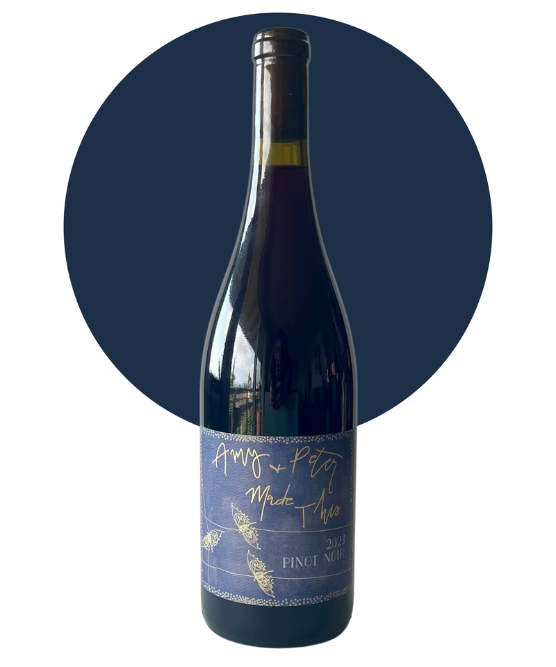 Bottle of Amy and Peter Made This Pinot Noir on white background with a dark blue circle