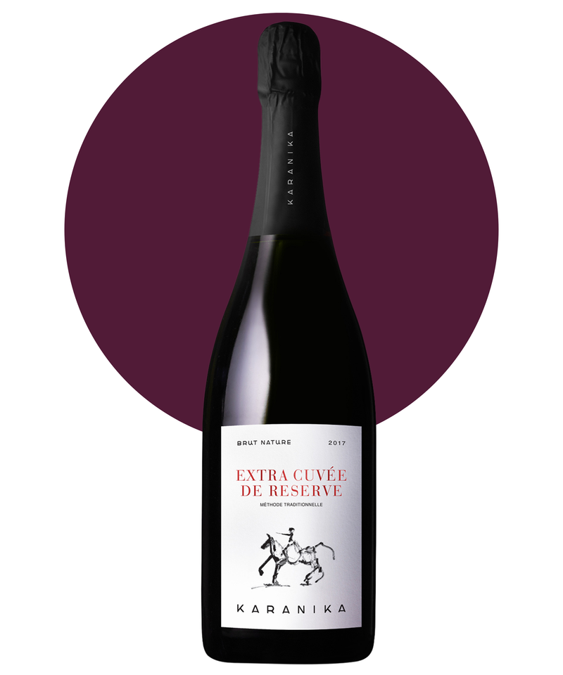 Bottle of Karanika Extra Cuvee de Reserve wine with a purple circular background